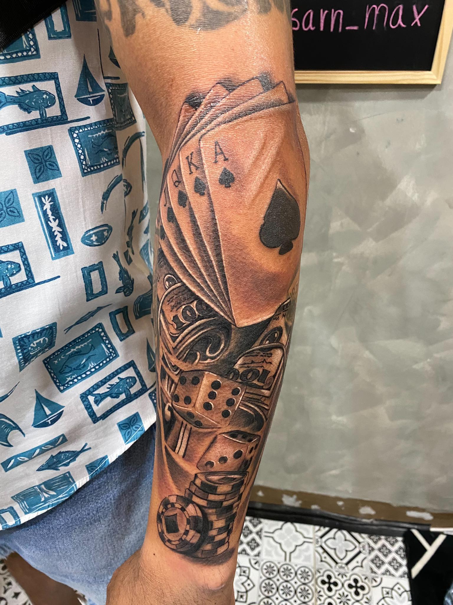 Cards, Dice, Gambling, Forearm, Black and Grey Tattoo in Pattaya. We are known for Japanese, Chicano, Realistic, New School, Old School, Neo Thai, Blackwork, and Bamboo Tattooing. Cards, Dice, Gambling, Forearm, Black and Grey Tattoo, Lethal Ink, Pattaya, 2024
