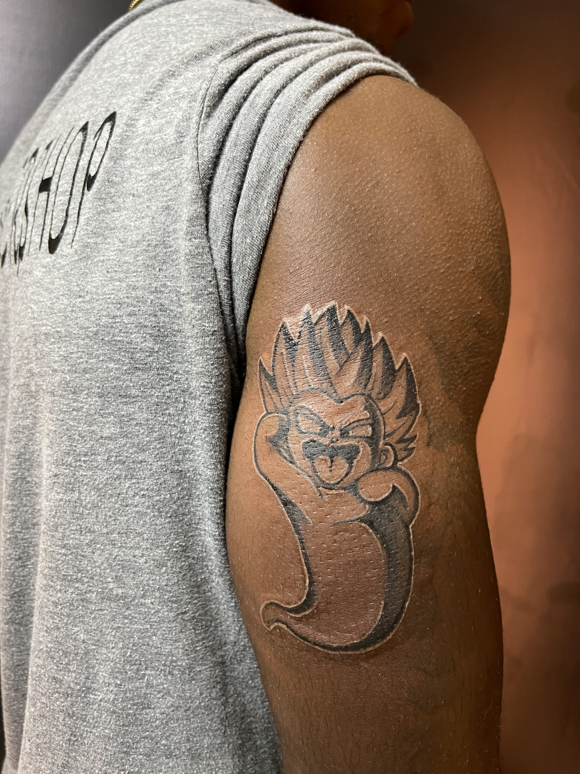 Black and grey, Character, Tricep Tattoo by Toon. He is a highly skilled tattoo artist at Lethal Ink Tattoo in Pattaya. He is celebrated for his expertise in Japanese, Chicano, Realistic, New School, Old School, Neo Thai, and Bamboo Tattooing. Toon, Black and Grey, character, Tricep Tattoo, Lethal Ink, Pattaya, 2024