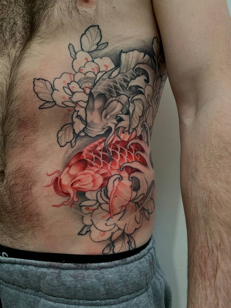 Japanese, Koi Fish, Rib Tattoo by Alek. She is a highly skilled tattoo artist at Lethal Ink Tattoo in Pattaya. She is celebrated for her expertise in Japanese, BlackWork, and Abstract styles. Alek, Japanese, Koi Fish, Rib Tattoo, Lethal Ink, Pattaya, 2024