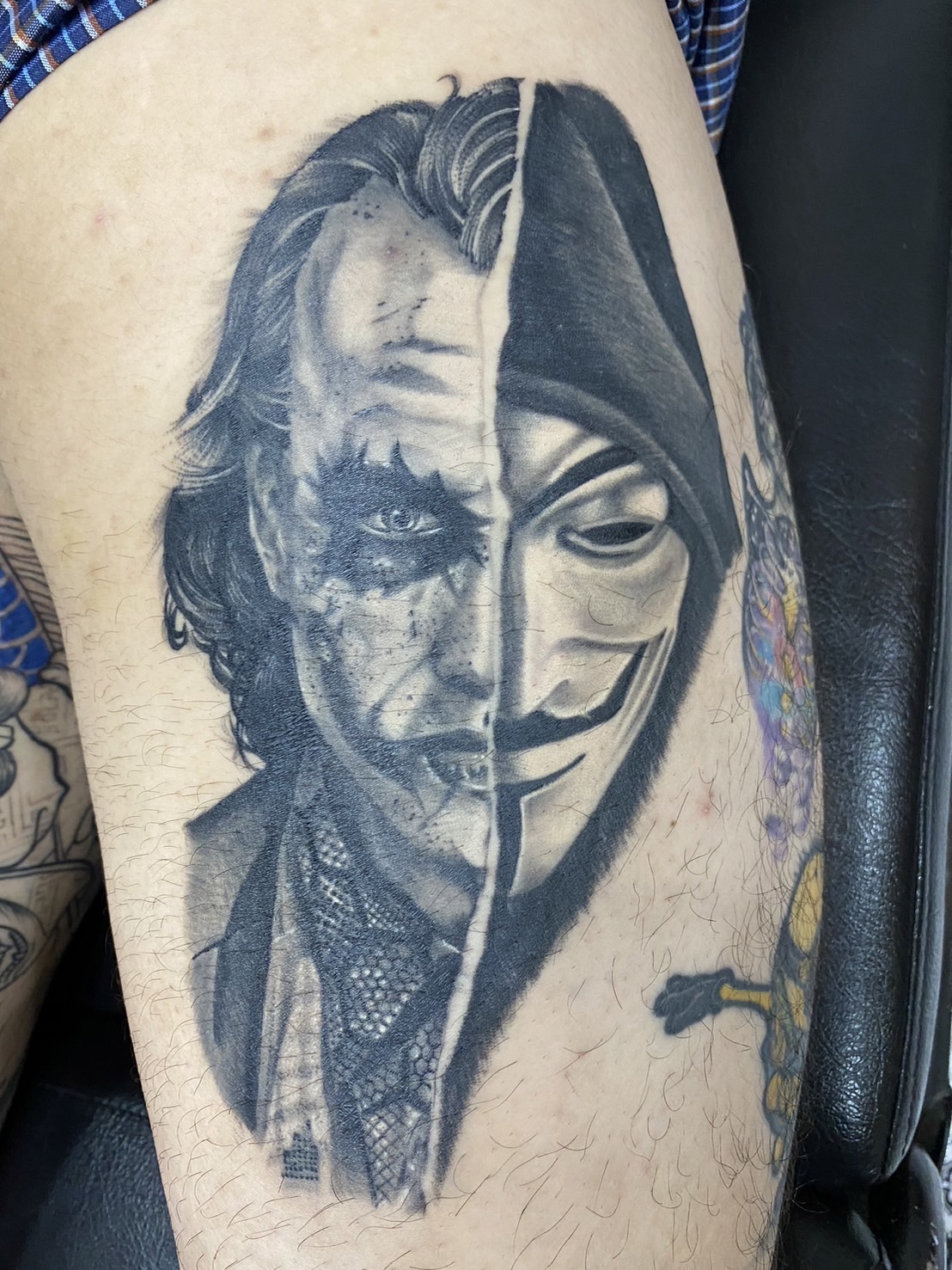 Black and Gray, Joker, anonymous, Portrait, leg tattoo by Max. He is a highly skilled tattoo artist at Lethal Ink Tattoo in Pattaya. He is celebrated for is expertise in black and grey, anime, manga, Thai art, and tribal motifs. Black and Gray, Joker, anonymous, Portrait, leg Tattoo, Max, Lethal Ink, Pattaya, 2024