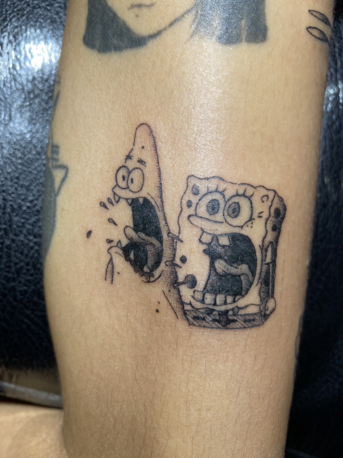 Spongebob, Patrick Black, Frightened tattoo by Max. He is a highly skilled tattoo artist at Lethal Ink Tattoo in Pattaya. He is celebrated for is expertise in black and grey, anime, manga, Thai art, and tribal motifs. Spongebob, Patrick Black, Frightened Tattoo, Max, Lethal Ink, Pattaya, 2024