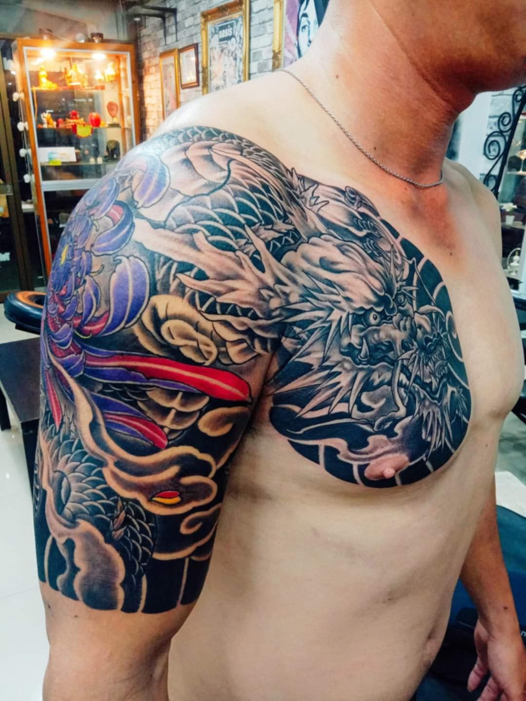 Japanese Style, Dragon, Black and Gray, Color, Chest Tattoo by Toon. He is a highly skilled tattoo artist at Lethal Ink Tattoo in Pattaya. He is celebrated for his expertise in Japanese, Chicano, Realistic, New School, Old School, Neo Thai, and Bamboo Tattooing. Japanese Style, Dragon, Black and Gray, Color, Chest, Toon Tattoo, Lethal Ink, Pattaya, 2024