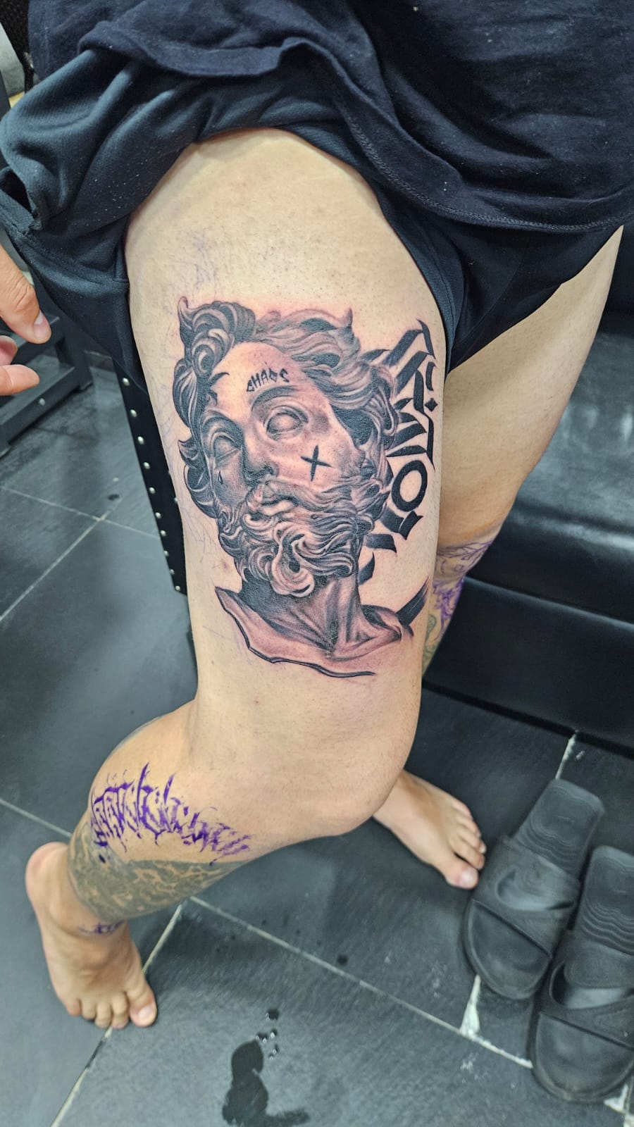 Greek Philosopher, Black and Grey, Thai Script, Thigh,Tattoo by Max. He is a highly skilled tattoo artist at Lethal Ink Tattoo in Pattaya. He is celebrated for is expertise in black and grey, anime, manga, Thai art, and tribal motifs. Greek Philosopher, Black and Grey, Thai Script, Thigh, Tattoo, Max, Lethal Ink, Pattaya, 2024