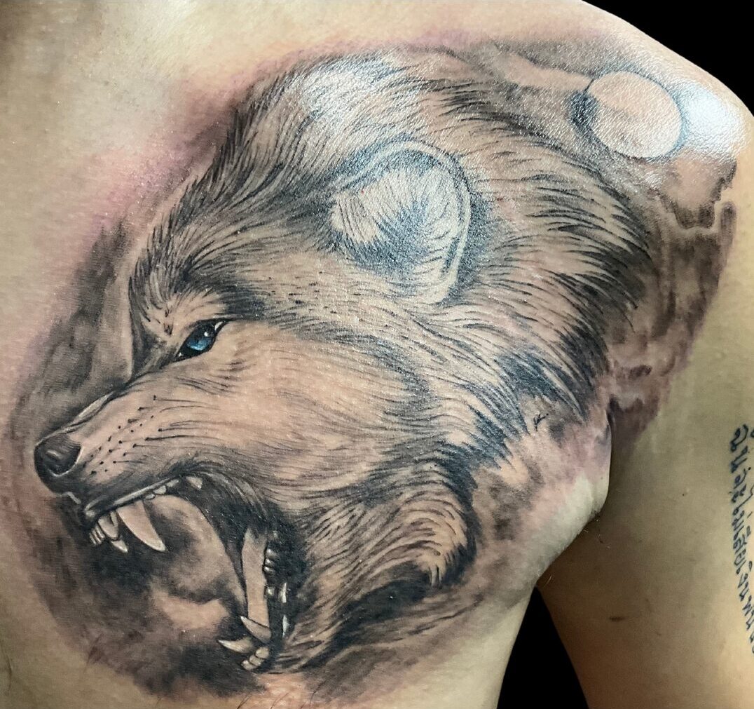 Realistic Wolf, Chest Tattoo by Ron. He is a highly skilled tattoo artist at Lethal Ink Tattoo in Pattaya. He is Known for is expertise in Watercolor Fine Line, Tribal, Realistic, Irezumi, Neo Thai, Quote, Japanese, and Blackwork. Ron, Tattoo Artist, Lethal Ink Tattoo, Pattaya, 2024