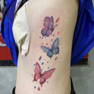 Butterfly, Color, Rib Tattoo by Max. He is a highly skilled tattoo artist at Lethal Ink Tattoo in Pattaya. He is celebrated for is expertise in black and grey, anime, manga, Thai art, and tribal motifs. Max, Butterfly, Color, Rib Tattoo, Lethal Ink, Pattaya, 2024