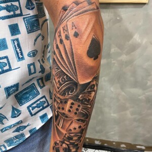 Cards, Dice, Gambling, Forearm, Black and Grey Tattoo in Pattaya. We are known for Japanese, Chicano, Realistic, New School, Old School, Neo Thai, Blackwork, and Bamboo Tattooing. Cards, Dice, Gambling, Forearm, Black and Grey Tattoo, Lethal Ink, Pattaya, 2024