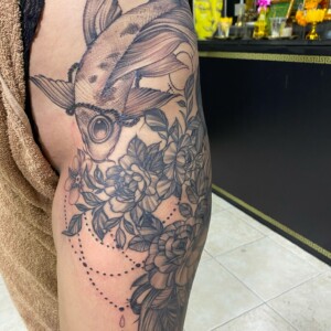 Black, Koi Fish, Hip Tattoo by Max. He is a highly skilled tattoo artist at Lethal Ink Tattoo in Pattaya. He is celebrated for his expertise in black and grey, anime, manga, Thai art, and tribal motifs. Max, Black, Koi Fish, Hip Tattoo, Lethal Ink, Pattaya, 2024