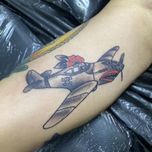 Airplane, Animated, Color, Arm tattoo by Max. He is a highly skilled tattoo artist at Lethal Ink Tattoo in Pattaya. He is celebrated for is expertise in black and grey, anime, manga, Thai art, and tribal motifs. Airplane, Animated, Color, Arm Tattoo, Max, Lethal Ink, Pattaya, 2024