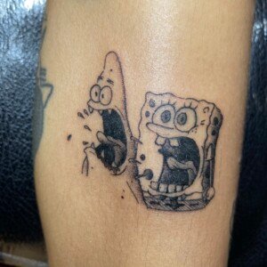 Spongebob, Patrick Black, Frightened tattoo by Max. He is a highly skilled tattoo artist at Lethal Ink Tattoo in Pattaya. He is celebrated for is expertise in black and grey, anime, manga, Thai art, and tribal motifs. Spongebob, Patrick Black, Frightened Tattoo, Max, Lethal Ink, Pattaya, 2024