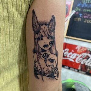 Sexy, Demon Girl, Black Tricep tattoo by Max. He is a highly skilled tattoo artist at Lethal Ink Tattoo in Pattaya. He is celebrated for is expertise in black and grey, anime, manga, Thai art, and tribal motifs. Sexy, Demon Girl, Black Tricep Tattoo, Max, Lethal Ink, Pattaya, 2024