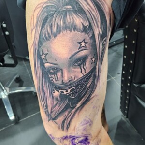 Chicano, Black and Gray, Woman, Face, Portrait, Thigh Tattoo by Toon. He is a highly skilled tattoo artist at Lethal Ink Tattoo in Pattaya. He is celebrated for his expertise in Japanese, Chicano, Realistic, New School, Old School, Neo Thai, and Bamboo Tattooing. Chicano, Black and Gray, Woman, Face, Portrait, Thigh Tattoo, Toon, Lethal Ink, Pattaya, 2024