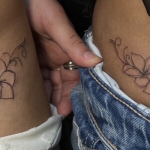 Fine line flower matching tattoo on arm by Apple at Lethal Ink Tattoo, Pattaya. Apple specializes in Fine Line, Floral, Minimal, Linework, and Delicate tattoos. Fine line flower matching tattoo on arm by Apple, tattoo artist at Lethal Ink Tattoo, Pattaya (2025)