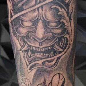 Black and grey Japanese Hannya tattoo with flowers by Apple at Lethal Ink Tattoo, Pattaya. Apple specializes in Japanese, Black & Grey, Fine Line, Ornamental, Minimal, and Script styles. Black and grey Japanese Hannya mask tattoo with flowers by Apple, tattoo artist at Lethal Ink Tattoo, Pattaya (2025)