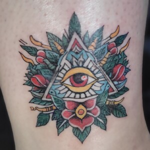 Traditional all-seeing eye ornamental color tattoo on arm by Apple at Lethal Ink Tattoo, Pattaya. Apple specializes in Traditional, Old School, Color, Ornamental, and Symbolic tattoos. Traditional all-seeing eye ornamental color tattoo on arm by Apple, tattoo artist at Lethal Ink Tattoo, Pattaya (2025)