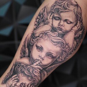 Realistic black and grey cherub angels tattoo by Sandy at Lethal Ink Tattoo, Pattaya. Sandy specializes in Realism, Black & Grey, Portrait, Illustrative, and Neo Traditional styles. Realistic black and grey cherub angels tattoo by Sandy, tattoo artist at Lethal Ink Tattoo, Pattaya (2025)