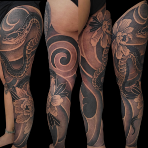 Blackwork Japanese snake and peony tattoo on leg by Sandy at Lethal Ink Tattoo, Pattaya. Sandy specializes in Japanese, Blackwork, Illustrative, Black & Grey, and Neo Traditional styles. Blackwork Japanese snake and peony tattoo on leg by Sandy, tattoo artist at Lethal Ink Tattoo, Pattaya (2025)